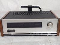 Front view of the Rotel RT-320 tuner showing the front panel, tuning knob, and display.