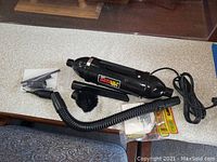 DATAVAC vacuum cleaner body and accessories laid out on table showing main unit, hose, and nozzles
