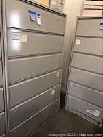 Photo of the six drawer lateral file cabinet in gray, showing the front side with all drawers closed.