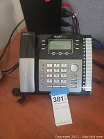 Telephone set showing front side with keypad, display, and function buttons