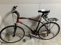 Full side view of maroon Diamondback Crestview bicycle showing frame, wheels, rack and seat