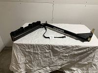 Full view of the bicycle rack showing the metal tubular frame with slots for 4 bike wheels and the 'Frontier' brand label.