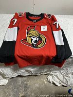 Front view of the red Ottawa Senators hockey jersey with number 71 and team logo on the chest.