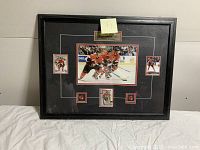 Framed Ottawa Senators hockey photo with cards and pins, shows warped condition of photo.