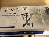 Box showing product name and image of the assembled electric flip down ceiling TV mount.