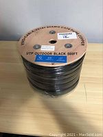 Top view of the wooden spool showing cable specifications, branding, and length.