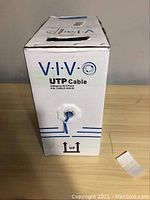 Front of the white cardboard box showing Vivo branding and UTP cable info with cable exiting the box.