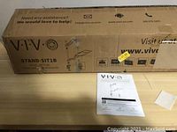 Cardboard box with VIVO branding and product label STAND-SIT1B, product packaging for sit to stand workstation desk mount.