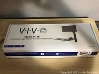 Closed retail packaging box for VIVO Stand-SIT1K sit to stand single monitor wall mount workstation.
