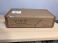 Photo of the original packaging box showing the VIVO brand and product model STAND-GM1BB with description 'Single Gaming Pneumatic Monitor Arm - Blue LED Lights'