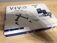 Top view of the unopened product box showing the VIVO Stand-LAP4 VESA laptop holder illustration and branding.