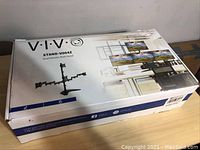 Box of VIVO STAND-V004Z Quad Monitor Desk Stand with product image and model shown.