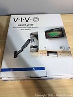 Photo of the closed VIVO MOUNT-V001G monitor wall mount box showing product branding and image on box front.