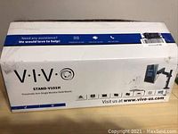 Box exterior showing VIVO STAND-V101H pneumatic arm single monitor desk mount model and product details.