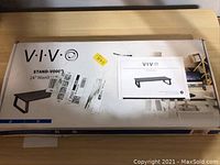 Box with branding and manual showing model and product image of monitor riser stand.