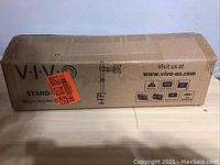 Closed box of Vivo single monitor mount stand, showing the product name and model on the box.