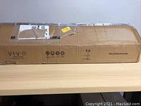 Closed VIVO branded cardboard box for the Mobile TV Cart TV04M stand showing some wear and tear.