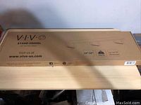Cardboard box showing VIVO brand and model information for a 39 inch monitor riser stand.