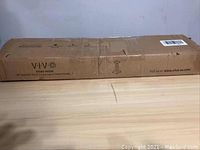 Cardboard box with Vivo branding and model SP03B indicating two speaker stands inside.