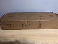 Cardboard shipping box with VIVO branding and product information.