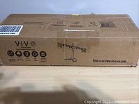 Closed shipping box labeled VIVO Dual Monitor Stand STAND-V002F showing product features and website.