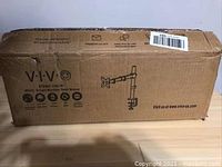 Closed cardboard box with the VIVO logo, product name STARIS-W0WW, and model information for the single monitor desk mount stand in white color.