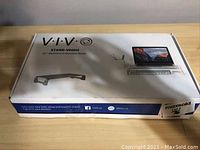 Box exterior showing brand VIVO, model STAND-V000H and a photo of the aluminum monitor riser on the front.