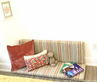 View of custom cushions arranged as a mini sofa with two decorative pillows and a plush rabbit toy.
