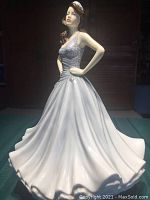 Front angle showing full flowing white skirt and pose with hands on hips.