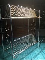 Front view of two-tier record stand showing both angled racks and decorative side rails