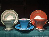 All three corset-shaped teacup and saucer sets side by side