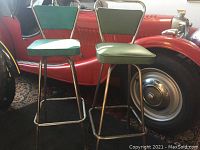 Two bar stools side by side showing mismatched vinyl colors and chrome frames