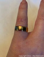Ring worn on finger showing size and style.