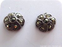 Close-up of the marcasite floral sterling silver stud earrings showing the detailed flower pattern and marcasite stones.