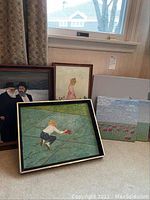 Six paintings displayed together, three framed, three unframed, with visible themes including young boy, young girl, Judaica, and nature.