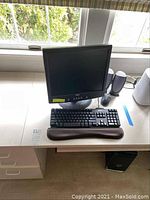 Dell 17-inch LCD monitor on stand with Dell keyboard, padded wrist rest, mouse and one speaker