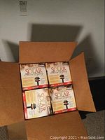 Open box showing 4 Malibu Solar Accent Lighting units in original packaging