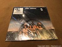 Front cover of ABBA Arrival LP sealed in original shrink wrap, showing the band and title.