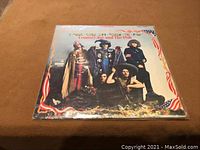 Front cover of Country Joe and The Fish LP showing band members wearing distinctive outfits with American flag decorations and scenic background.