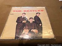 Front cover of Introducing The Beatles LP showing band portrait and album title.