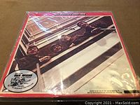 Photo of The Beatles 1962-1966 LP album cover showing the band members looking down from a balcony, with red border and Vinyl Museum sticker.