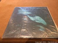 Front cover of Bob McBride LP "Sea of Dreams" showing album art and title within plastic sleeve.