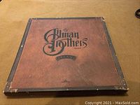 Closed view of the front of the Allman Brothers Band CD box set titled "Dreams". Shows faux leather look with band logo.