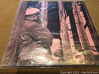 Front cover of Bessie Griffin Travelin' LP showing a man in profile wearing a hat, standing by a door frame.