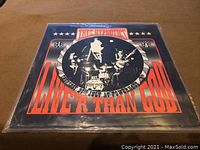 Front of Thee Hypnotics Live 'R Than God album cover showing black and white band photo with red text.