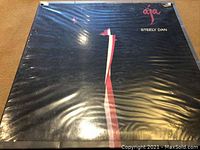 Front cover of Steely Dan "Aja" vinyl LP album wrapped in plastic sleeve.