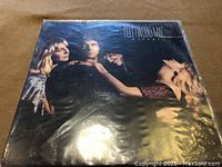 Front cover of Fleetwood Mac Rumours vinyl LP showing band members in black and white photography and album title.