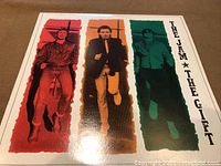 Front cover showing band members in colored vertical panels with album and band title