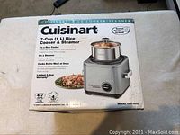 Front of box showing Cuisinart 7-Cup Rice Cooker & Steamer with product image and features.