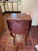 Full view of vintage side table showing cabriole legs, wooden surface, and overall condition.